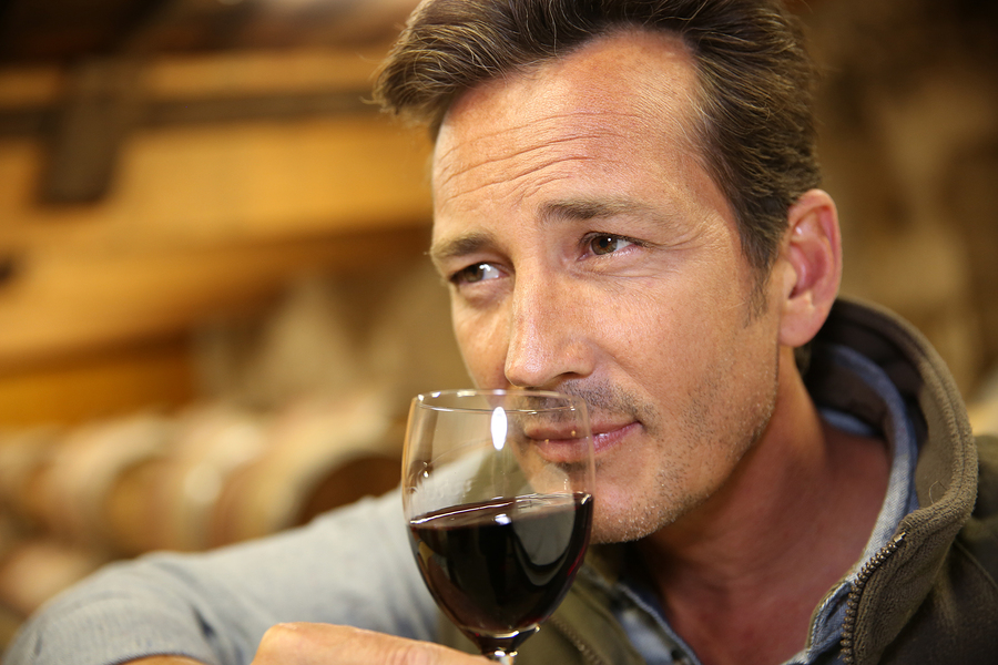 "Winemaker tasting red wine in cellar" says the stock photo caption. I like "Handsome model sniffs wine from a really tiny glass."