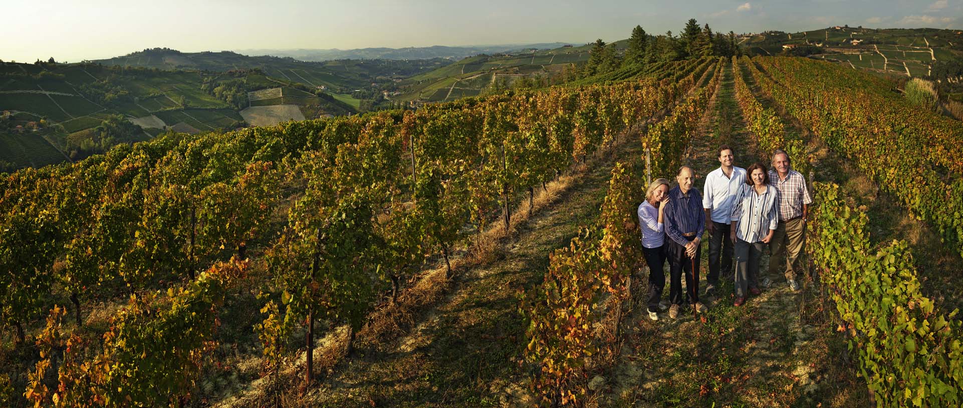 The Colla family stands in the Bricco del Drago vineyard. ©Poderi Colla