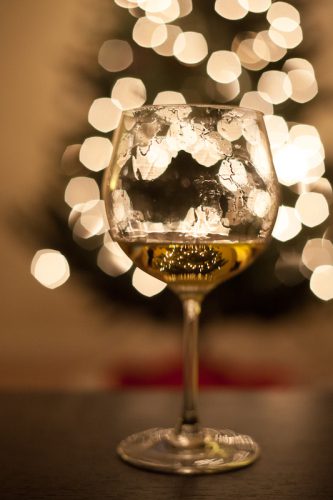 Glass of ice wine in front of a Christmas tree