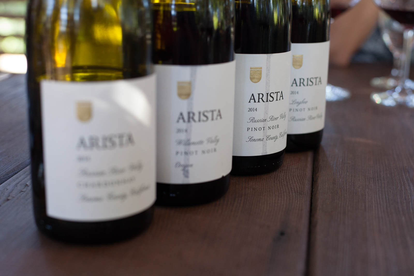 Bottles of wine at a wine tasting at Arista Winery. ©Kevin Day / Opening a Bottle