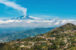 Smoking Etna volcano over Sicily, Italy