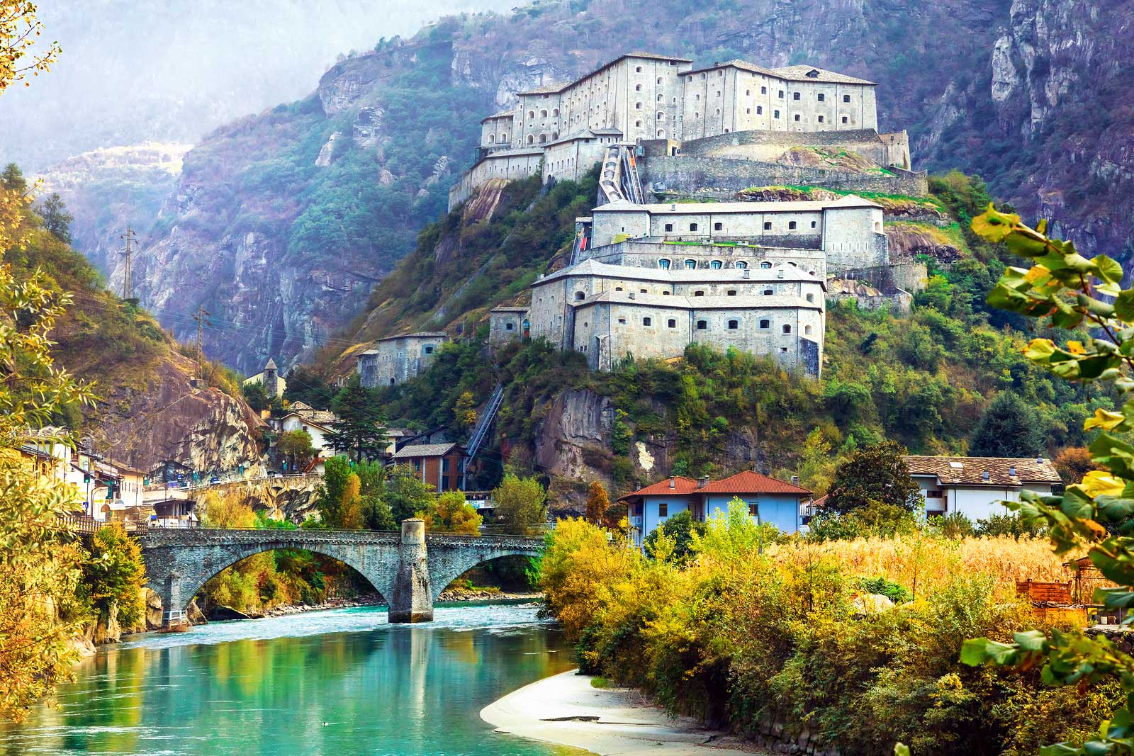 A fortress guards the Dora Baltea River in Valle d'Aosta, Italy.