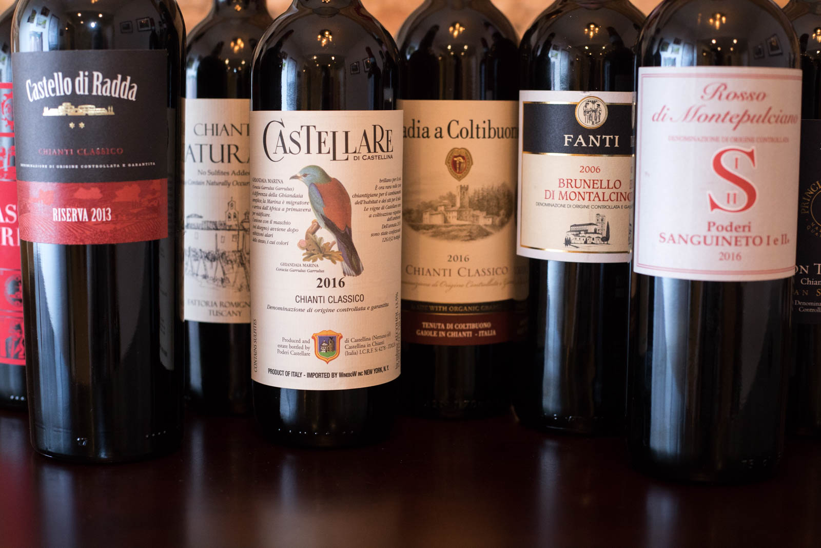 Wine bottles of Tuscany's various Sangiovese wines. ©Kevin Day/Opening a Bottle