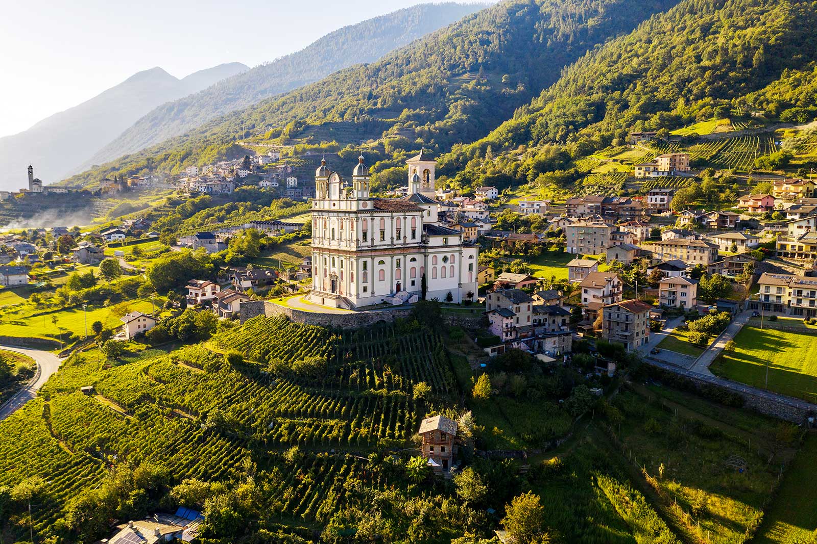 Chiesa della Santa Casa della Madonna Nera di Loreto crowns the vineyards of Valtellina in northern Lombardy, Italy.