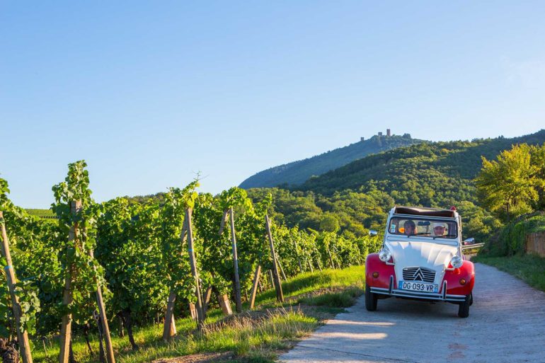 Maxime and Sophie drive an antique Citroen through the vineyards because ... why not? (Promotional photo provided by ©Barmès-Buecher)