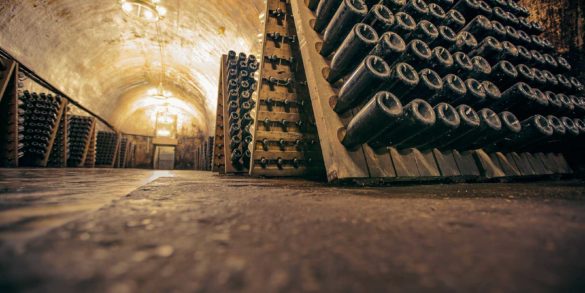 A Champagne Cellar with bottles in riddling racks.