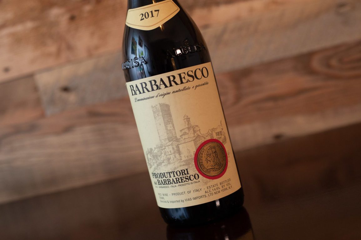 Bottle of Produttori del Barbaresco Barbaresco on tilted angle with wood wall background. ©Kevin Day/Opening a Bottle