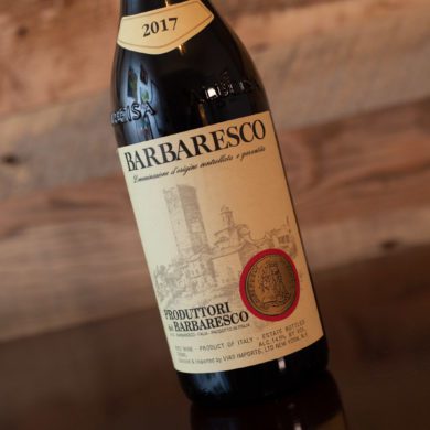 Bottle of Produttori del Barbaresco Barbaresco on tilted angle with wood wall background. ©Kevin Day/Opening a Bottle