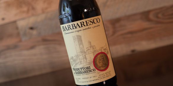 Bottle of Produttori del Barbaresco Barbaresco on tilted angle with wood wall background. ©Kevin Day/Opening a Bottle