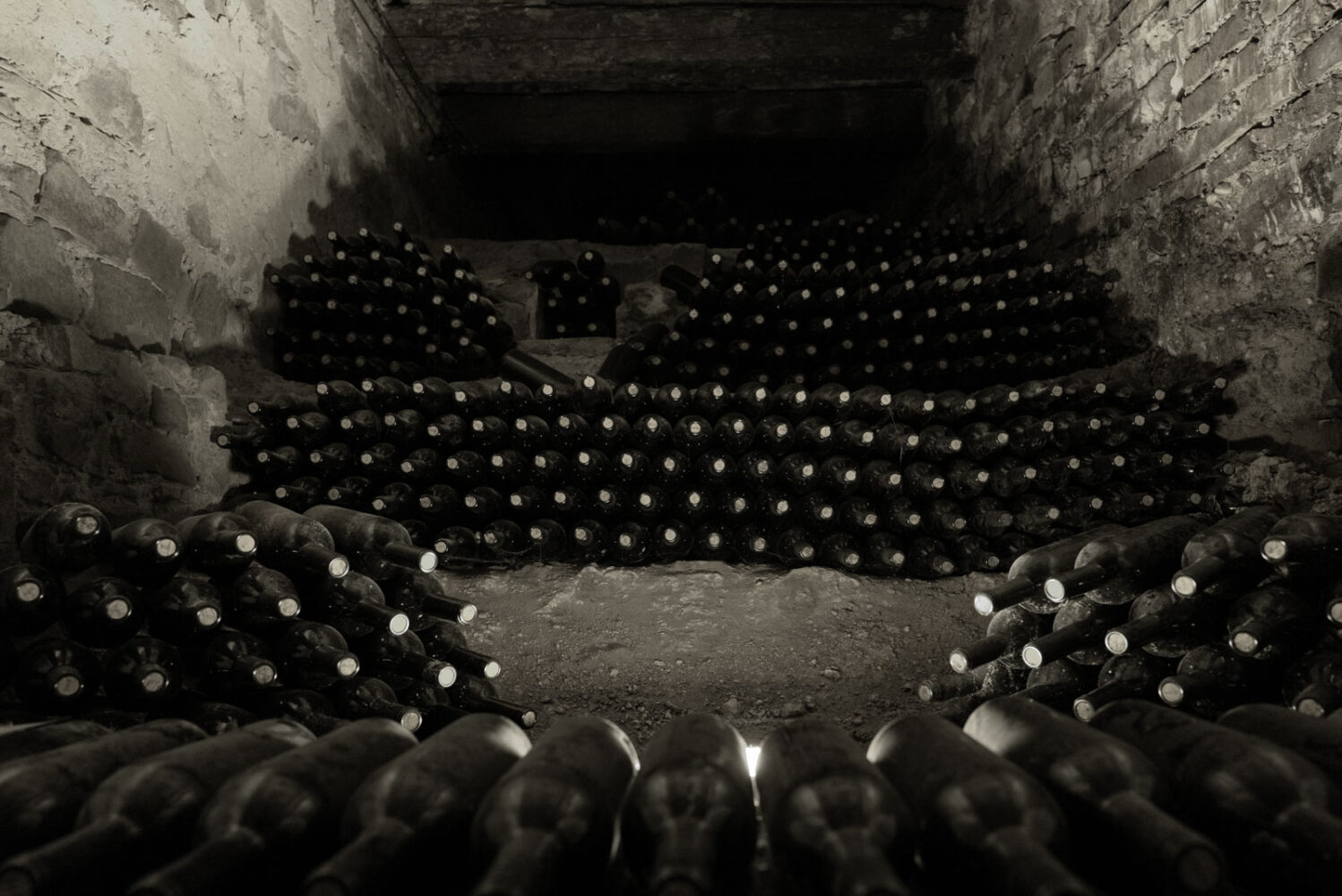 Wine bottles in an ancient cellar. ©Kevin Day/Opening a Bottle