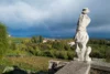 Rainbow and armless white marble statue at the Rosazzo Abbey in Friuli, Italy.