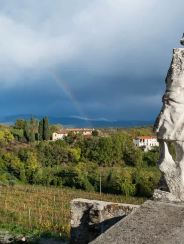 Rainbow and armless white marble statue at the Rosazzo Abbey in Friuli, Italy.