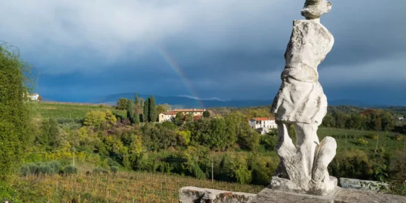 Rainbow and armless white marble statue at the Rosazzo Abbey in Friuli, Italy.