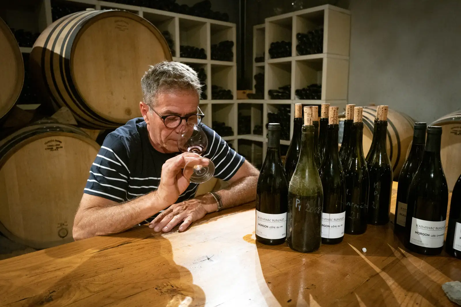 Winemaker Jean-Marc Burgaud tasting wine in his cellar in Villé-Morgon, Beaujolais, France.