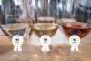 Three wine glasses with awards slapped on them