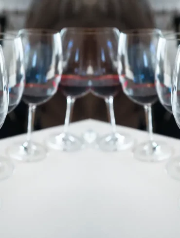 Mirror image of red wine glasses.