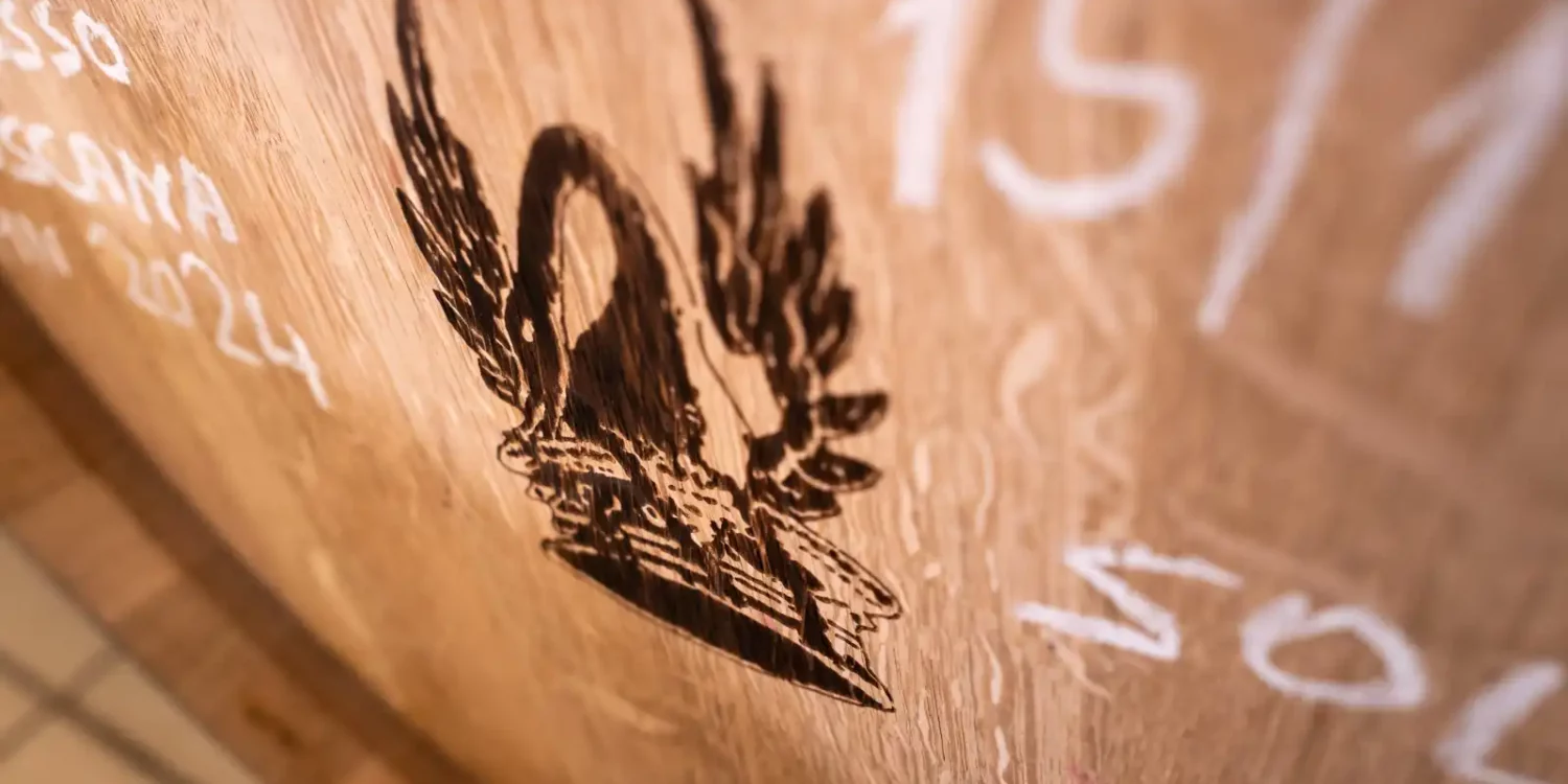 Emblem of Tenuta di Trinoro on a wood barrel at Tenuta di Trinoro, Val d’orcin, Tuscany.