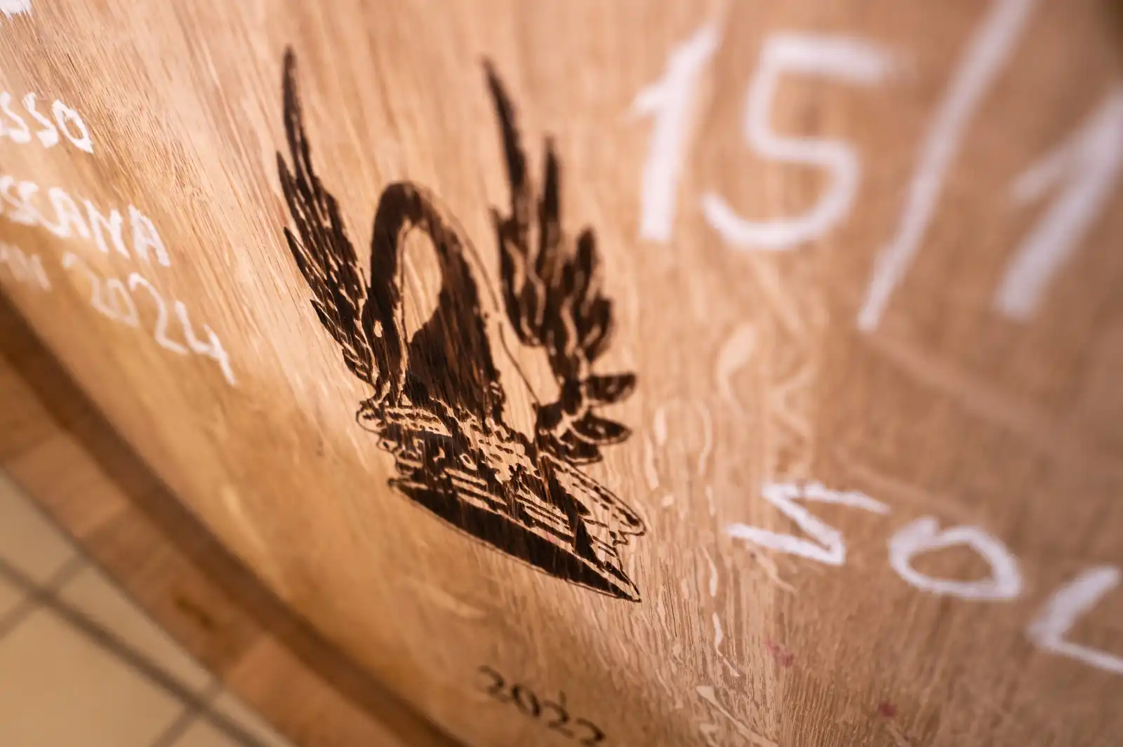 Emblem of Tenuta di Trinoro on a wood barrel at Tenuta di Trinoro, Val d’orcin, Tuscany.