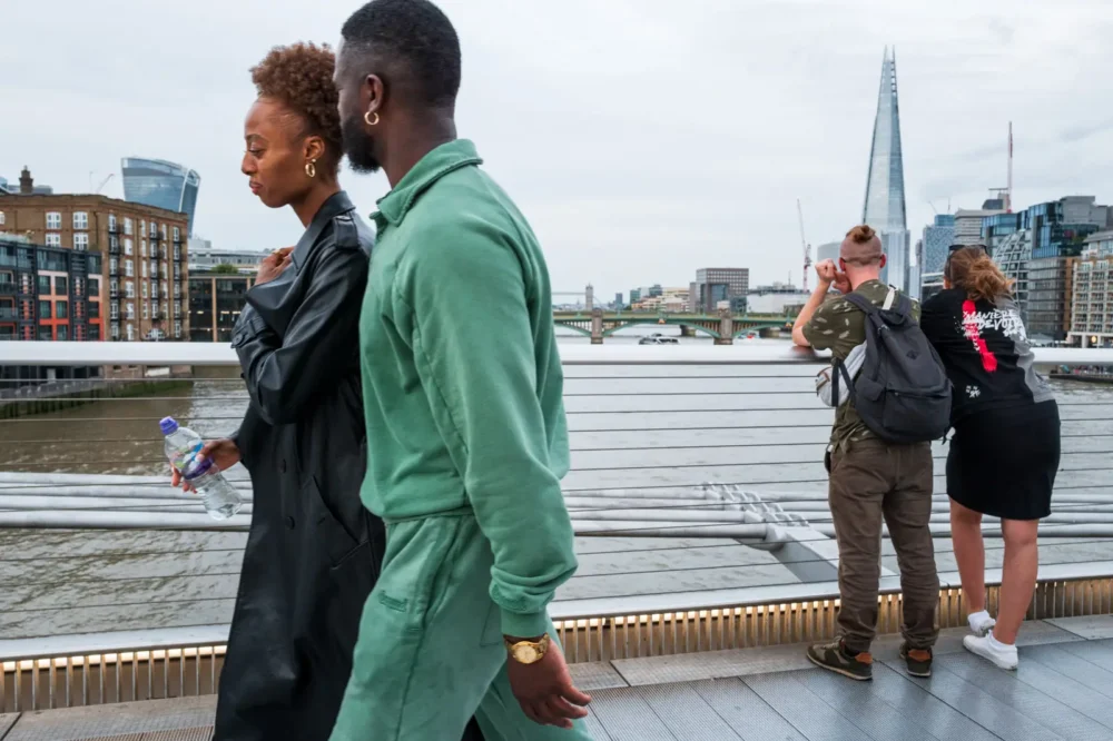 Pedestrians on the Millennium Bridge with the Shard in the distance, London, England, UK.