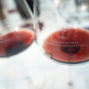Two red wine glasses with Brunello di Montalcino wines in them.