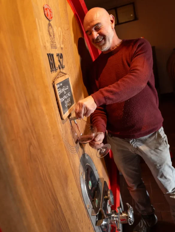 Winemaker Gianni Pignattai pours Brunello from a large oak barrel
