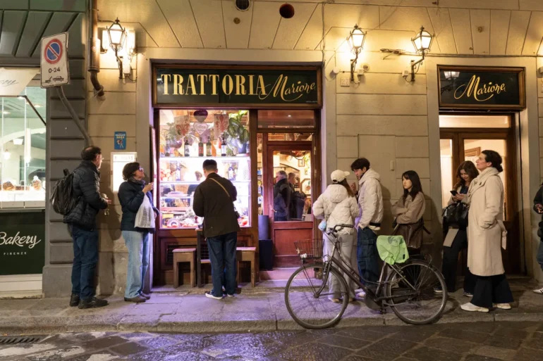Trattoria Marione in Florence and a hungry crowd lining up at night.