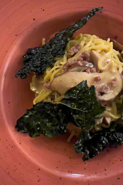 Fresh tagliolino pasta with porcini mushrooms, prosciutto crudo and crispy black cabbage. ©Kevin Day/Opening a Bottle
